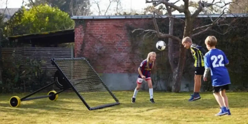 Kids practicing with m-station soccer rebounder from Munin Sports